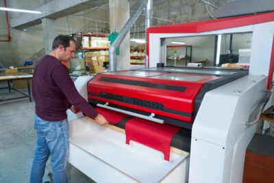Engineer Working On Laser Cutting Machine For Laser Cut Projects Engineer Working On Laser Cutting Machine For Laser Cut Projects
