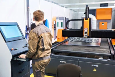Engineer Working On Cutting Metal With Laser Cutting Machine Engineer Working On Cutting Metal With Laser Cutting Machine