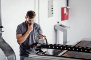 Laser Cutting Aluminum, Engineer Setting Up Laser Cutter Laser Cutting Aluminum, Engineer Setting Up Laser Cutter