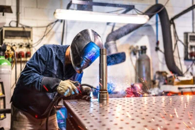 Metal Welding - Working Wearing Safety Gear And Welding A Metal Pipe Metal Welding - Working Wearing Safety Gear And Welding A Metal Pipe